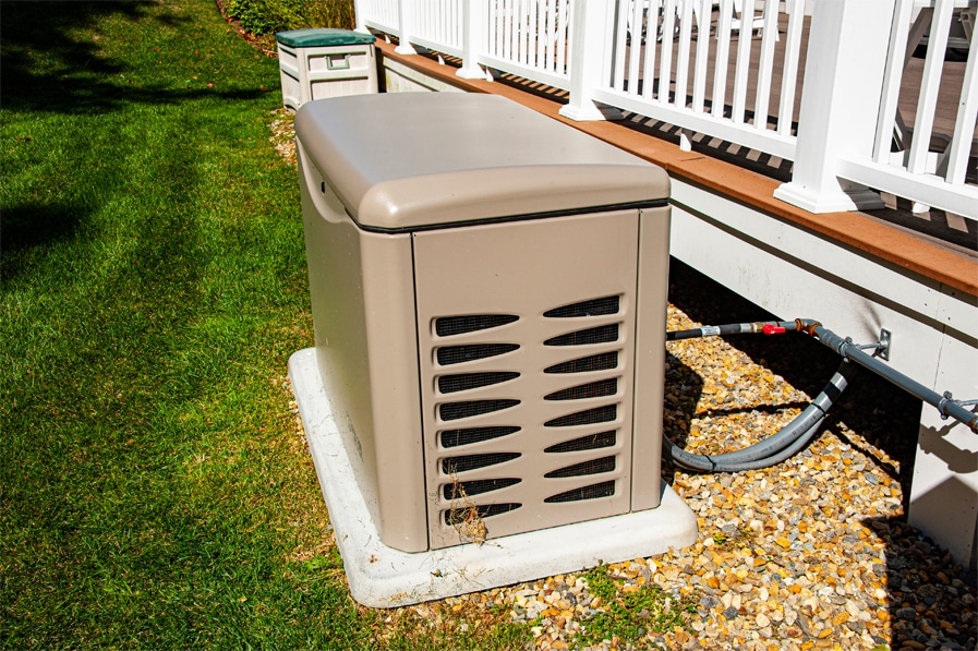 installed hvac generator on a green lawn near a residential home porch